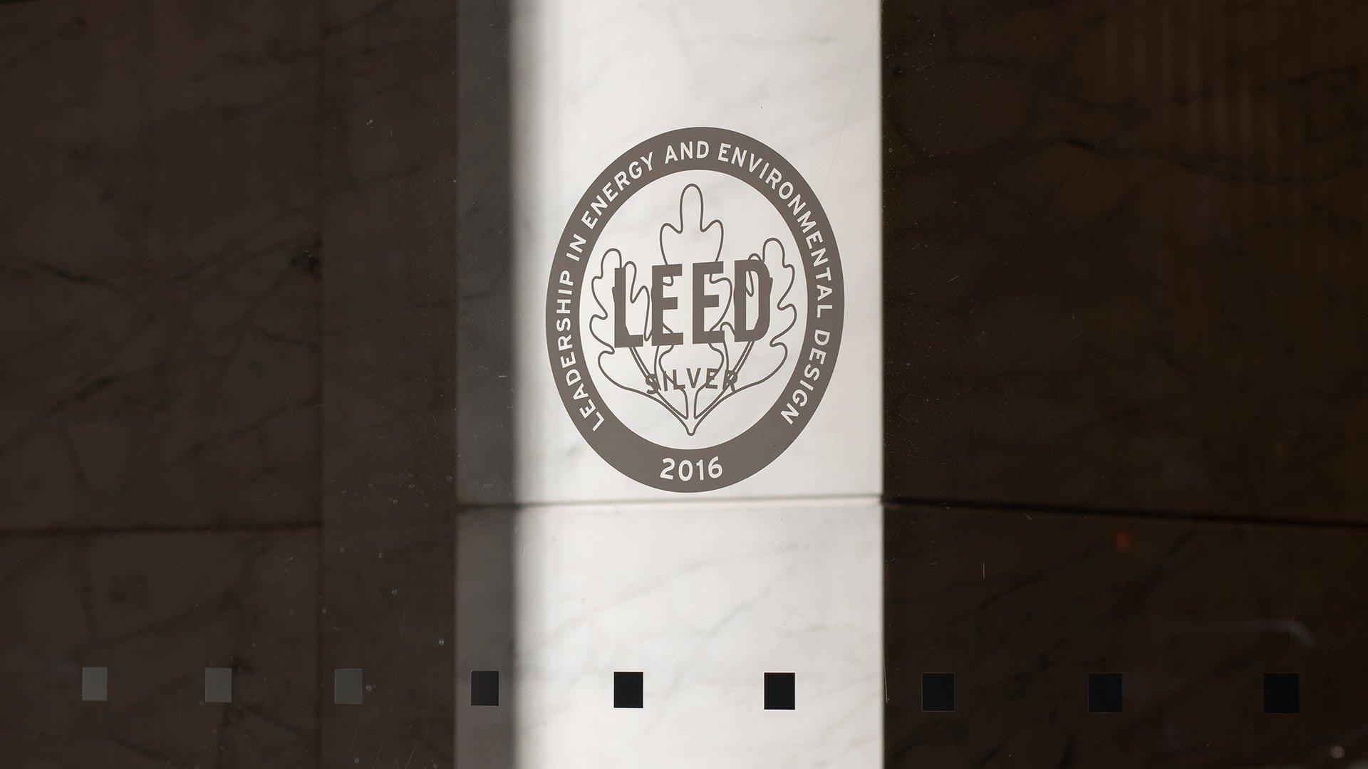 The LEED Silver certification icon on a glass door.